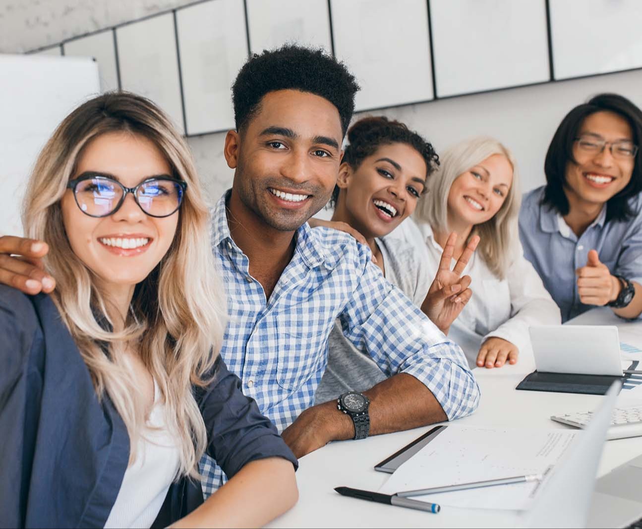 stock-photo-black-office-worker-in-checkered-shirt-embracing-blonde-secretary-girl-while-she-making-selfie-1080651953