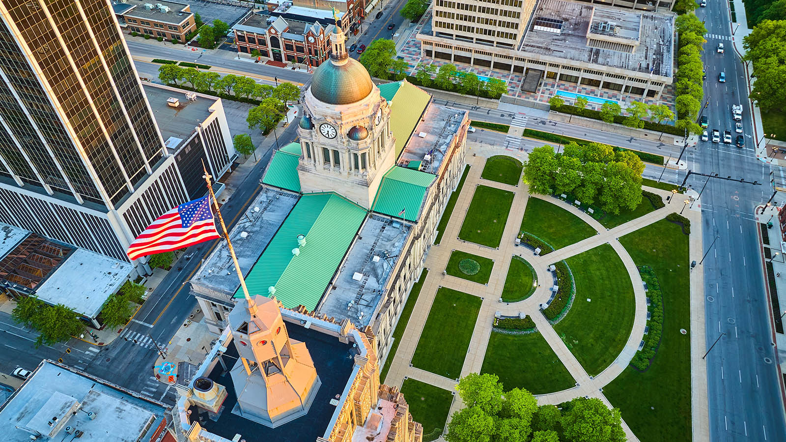 usa-flag-red-white-and-blue-over-downtown-fort-wayne-courthouse-aerial-summer-sunrise